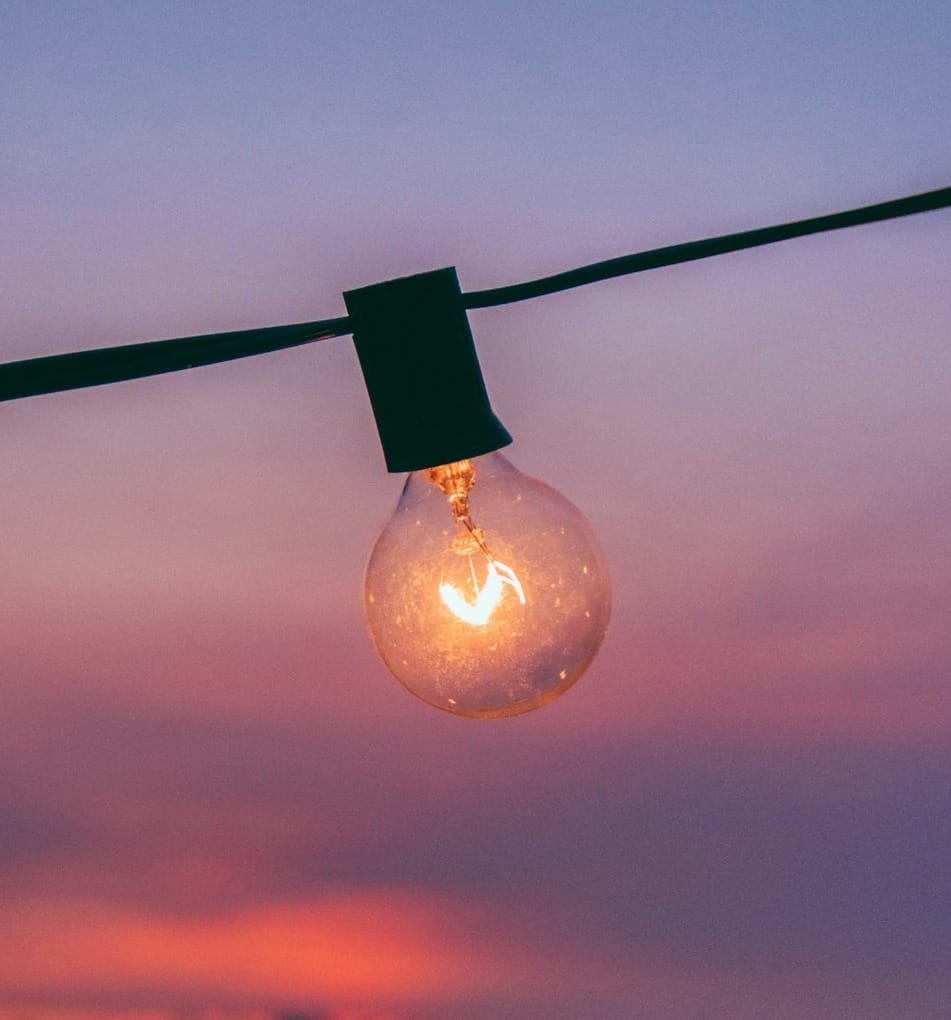 light bulb with sunset in background