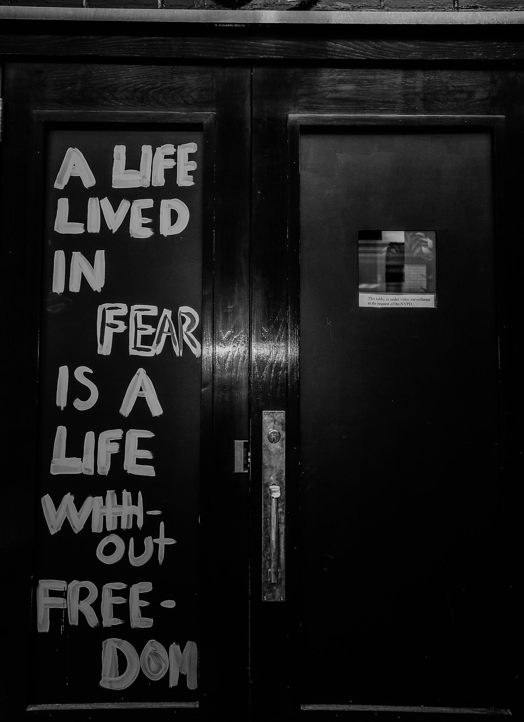 "A life lived in fear is a life without freedom" painted on black doors