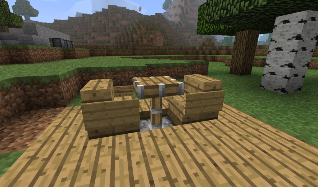A piston table with two chairs in Minecraft on a wooden floor.