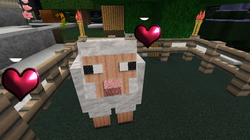 A white minecraft sheep in a pen with two red hearts floating by its head.