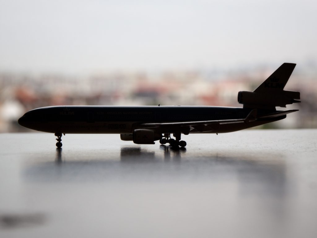 a toy airplane with a blurry grey background