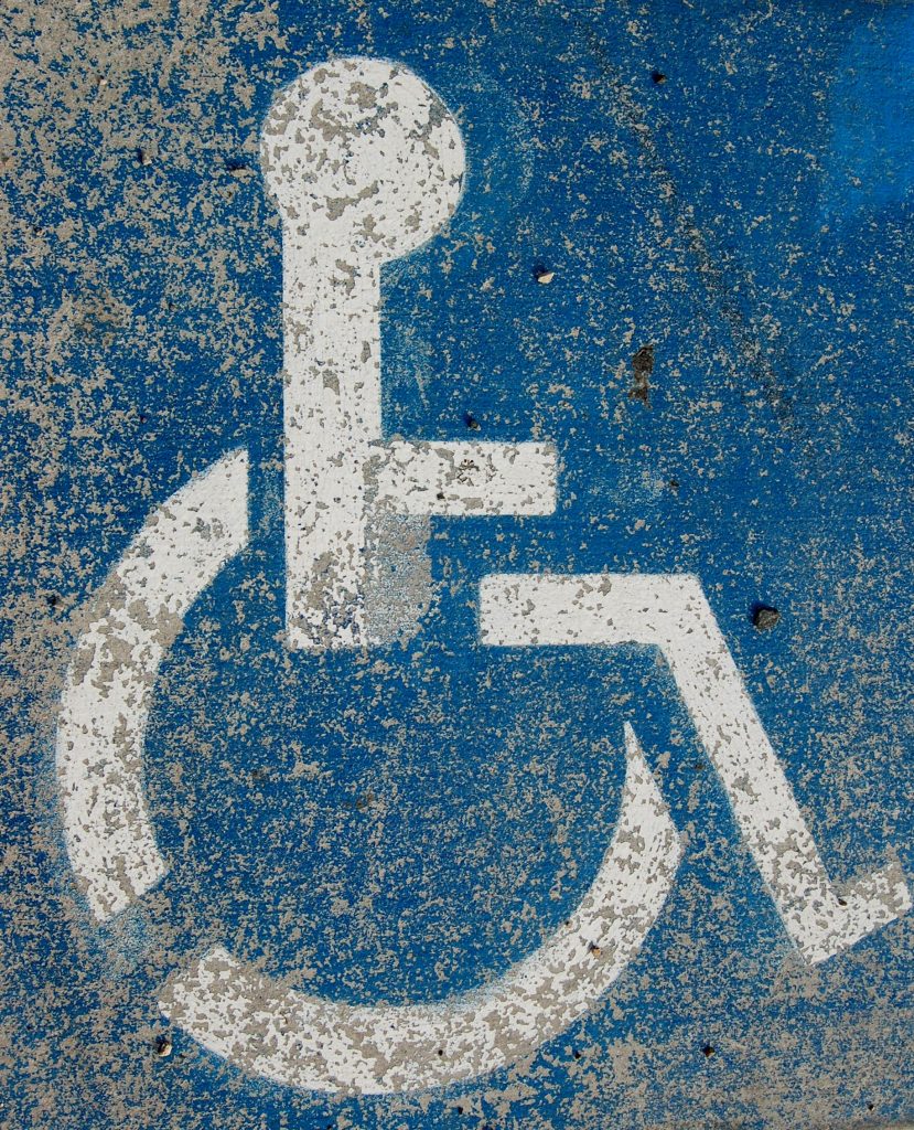 handicap sign on pavement, dirty from road