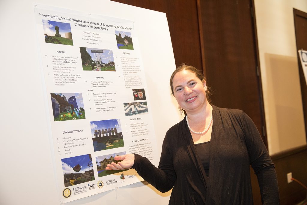 Me posing, smiling, in front of a scientific poster about Minecraft for Children with autism.